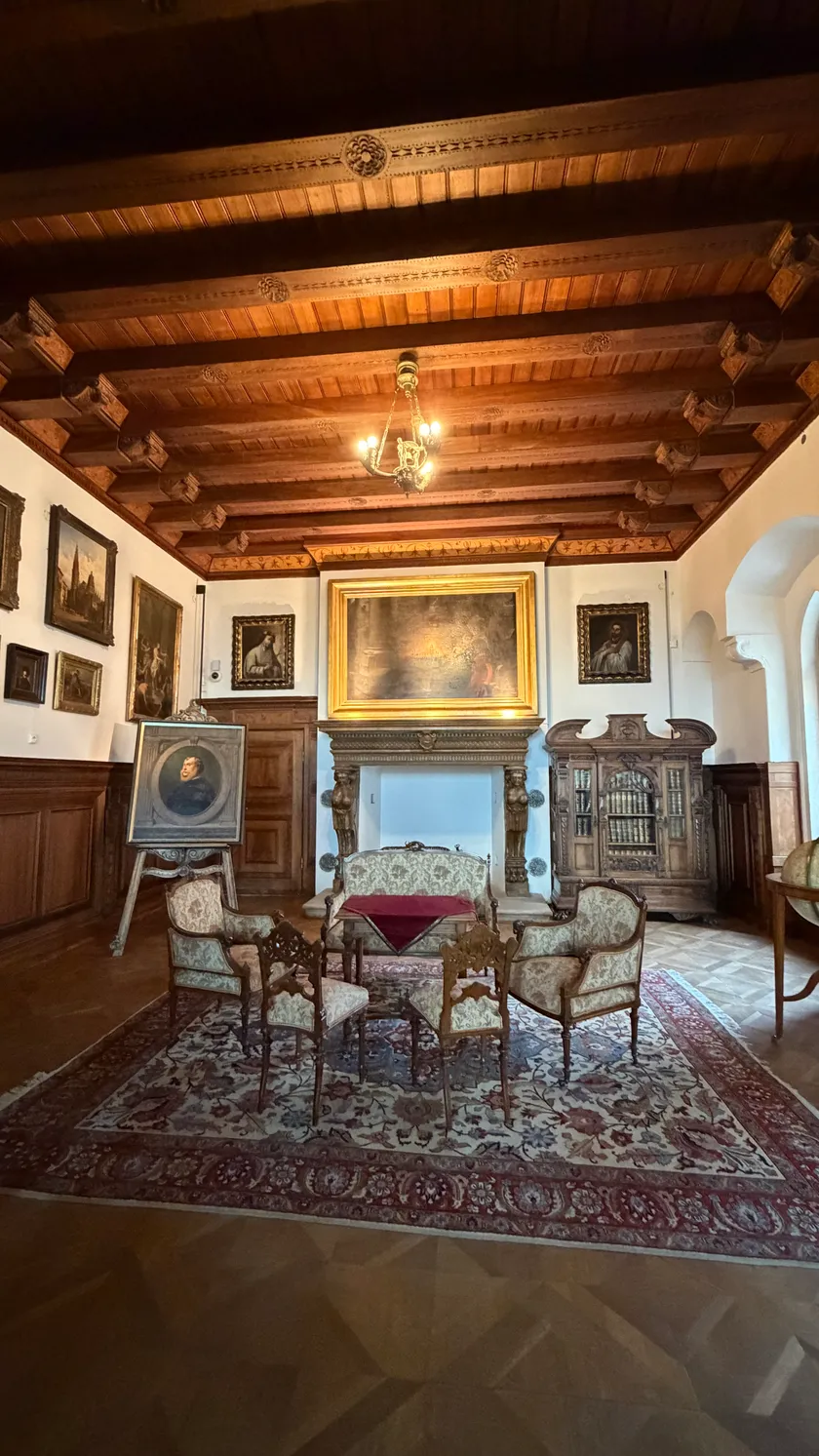 Ornate castle interior hall with paintings and period furniture