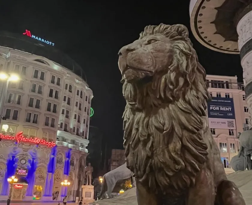 Bronze lion statue with the Marriott hotel in the background